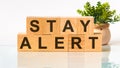 Stay alert word written on wood block. Faqs text on table, concept Royalty Free Stock Photo