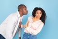 Stay away from me. African american couple, middle aged man in love reaching and trying to kiss confused young woman Royalty Free Stock Photo