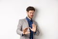 Stay away. Reluctant businessman step back with concerned disgusted face, raising hands to block bad offer, rejecting Royalty Free Stock Photo