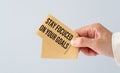 STAY FOCUCED ON YOUR GOALS Text on Stickers In Hand on Light Background. Royalty Free Stock Photo