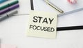 STAY FOCUSED man hand notebook and other office equipment such Royalty Free Stock Photo