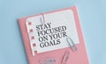 stay focused on your goals text on notebook and pen. Royalty Free Stock Photo