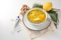 Stay healthy in the cold and flu season with chicken soup, ginger and lemon as home remedies, fiber thermometer and tablets for Royalty Free Stock Photo