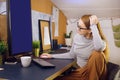 Stay home, a chic girl works in a homely atmosphere. Girl freelancer working at a computer with glasses