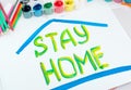 Stay at home. Children`s drawing with gouache paints on a white sheet.Campaign on social networks for the prevention of