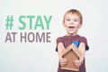 Stay home concept. Coronavirus prevention. Boy holds small house. Staing home in quarantine Royalty Free Stock Photo