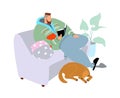 Stay at home concept, man sitting at his home on sofa at room with dog, reading book or learning, quarantine Royalty Free Stock Photo