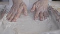 Stay at home for coronavirus lockdown concept: make pizza at home. Slow motion close up of man rolls out the pizza dough with his