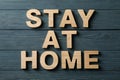 Stay at home made of wooden letters on background. Quarantine