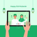 Stay Home online video call with family for Eid Mubarak Islamic festival celebration during covid 19 pandemic. Hand holding tablet