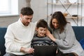 Stay home. Portrait of smiling father, mother and son using laptop for a online meeting, video call, video conference Royalty Free Stock Photo