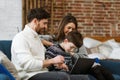 Stay home. Portrait of smiling father, mother and son using laptop for a online meeting, video call, video conference Royalty Free Stock Photo