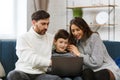 Stay home. Portrait of smiling father, mother and son using laptop for a online meeting, video call, video conference Royalty Free Stock Photo