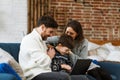 Stay home. Portrait of smiling father, mother and son using laptop for a online meeting, video call, video conference Royalty Free Stock Photo