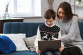 Stay home. Portrait of smiling mother and son using laptop for a online meeting, video call, video conference with Royalty Free Stock Photo