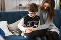 Stay home. Portrait of smiling mother and son using laptop for a online meeting, video call, video conference with Royalty Free Stock Photo