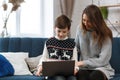 Stay home. Portrait of smiling mother and son using laptop for a online meeting, video call, video conference with Royalty Free Stock Photo