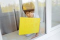 Stay at home quarantine coronavirus pandemic prevention. Sad child both in protective medical masks near windows and looks out Royalty Free Stock Photo