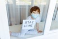 Stay at home quarantine coronavirus pandemic prevention. Sad child both in protective medical masks near windows and looks out Royalty Free Stock Photo