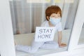 Stay at home quarantine coronavirus pandemic prevention. Sad child both in protective medical masks near windows and looks out Royalty Free Stock Photo