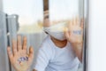 Stay at home quarantine coronavirus pandemic prevention. Sad child both in protective medical masks near windows and looks out Royalty Free Stock Photo