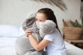 Stay at home quarantine coronavirus pandemic prevention. Sad child in protective medical mask and his elephant both Royalty Free Stock Photo