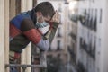 Stay home quarantine portrait of of 30s handsome man in face mask sad and depressed at home balcony during covid19 lockdown Royalty Free Stock Photo