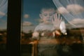 Stay home for quarantine prevention of the coronavirus pandemic. A sad child sitting on a windowsill and looking out the window. V Royalty Free Stock Photo