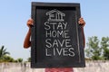 `Stay home save lives` concept written on blackboard. Royalty Free Stock Photo