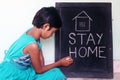 `Stay home`  concept written on blackboard. Royalty Free Stock Photo