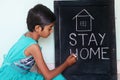 `Stay home`  concept written on blackboard. Royalty Free Stock Photo