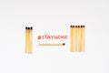 Stay at Home. Social distancing concept as stayathome. Matchsticks burn, one piece prevents the fire from spreading. Concept how Royalty Free Stock Photo