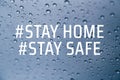 Stay at home social media campaign for coronavirus prevention. Stay home stay safe concept. Close up of rain drops on the window Royalty Free Stock Photo