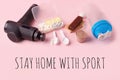 Stay home with sport. Therapeutic percussive massage gun, fit meal, pills, sport energy bar on pink background - concept of modern Royalty Free Stock Photo