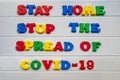 Stay home stop the spread of covid-19  Sign & Symbol, plastic letter on white wood background Royalty Free Stock Photo