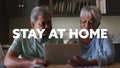 Stay at home text against african american senior couple suing digital tablet at home