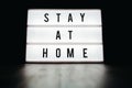 Stay home - text on a lightbox display on black background