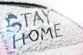 Stay at home text on snowy car window. Protection against virus and infection via lockdown - concept of coronavirus quarantine or