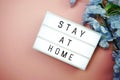 Stay at Home word letter in light box on pink background