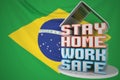 Laptop and STAY HOME WORK SAFE text on the Brazilian flag background. Remote work during coronavirus disease outbreak in