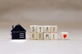 Stay home written with wooden cubes and miniature house, Covid-19, health stay at home. Quarantine concept. background Royalty Free Stock Photo