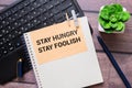Stay Hungry Stay Foolish text on notepad, concept background. Royalty Free Stock Photo