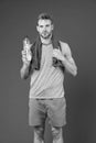 Stay hydrated. Man with towel on shoulders hold bottle. Athlete drink hydration mix with more electrolytes. Hydrates