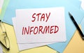 STAY INFORMED text on paper on the colorful paper background