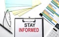 STAY INFORMED text on paper sheet with chart,color paper and calculator Royalty Free Stock Photo