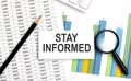 STAY INFORMED text on white card on the chart background Royalty Free Stock Photo