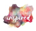 Stay inspired hand lettering phrase on watercolor imitation color splash with drop shadow over white background