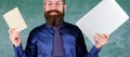 Stay modern with technology. Teacher bearded hipster holds book and laptop. Choose right teaching method. Teacher