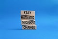 stay motivated throughout change symbol. Concept words stay motivated throughout change on wooden blocks. Beautiful blue Royalty Free Stock Photo