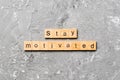 Stay motivated word written on wood block. Stay motivated text on cement table for your desing, concept Royalty Free Stock Photo
